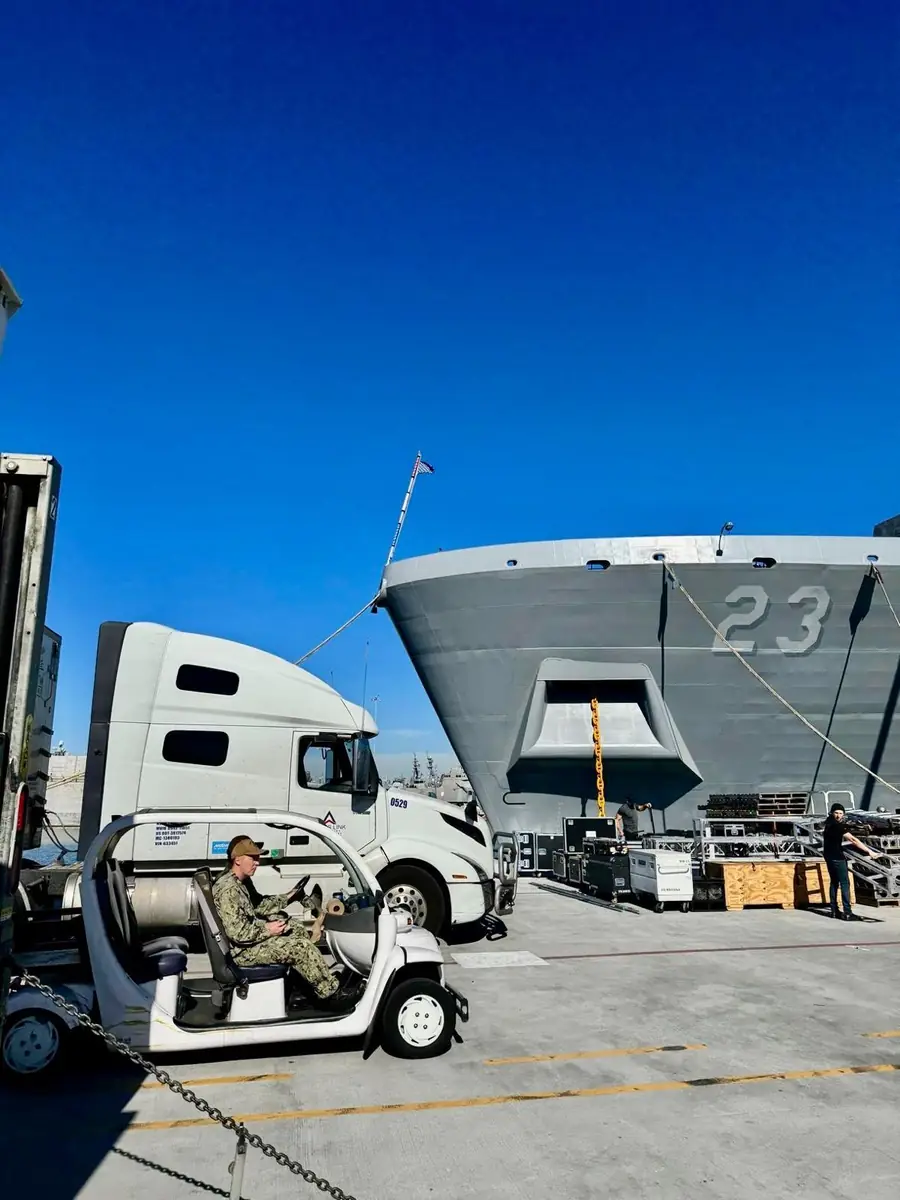 Trans Link truck alongside a naval vessel
